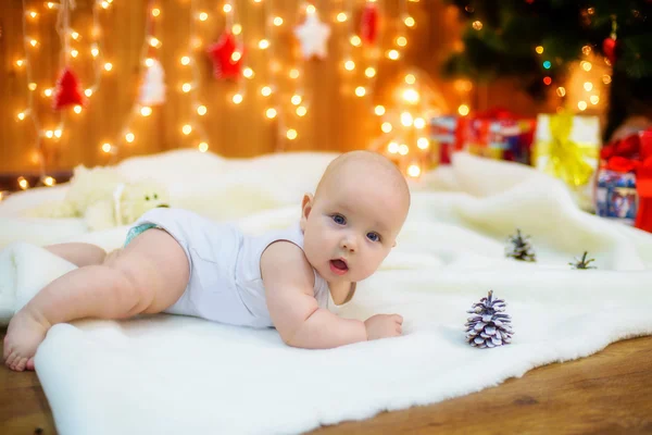 Little baby with gifts at Christmas tree — Stock Photo, Image