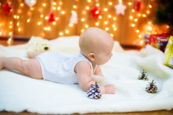 Little baby with gifts at Christmas tree — Stock Photo, Image