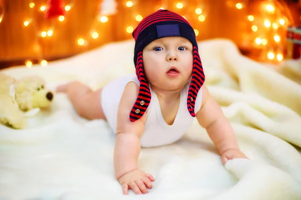 Little baby with gifts at Christmas tree — Stock Photo, Image