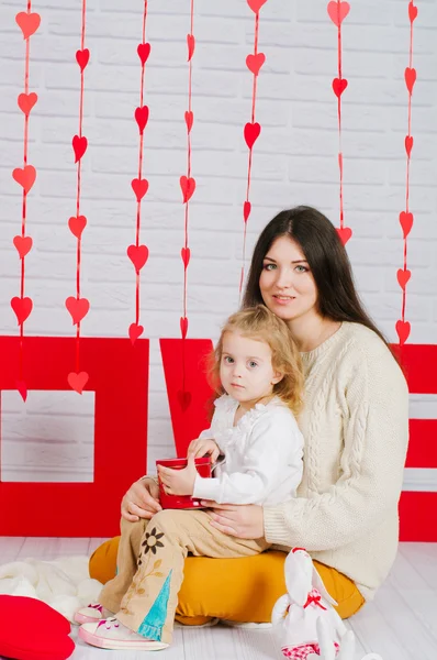 Молодая мать с маленькой дочерью с украшением День Святого Валентина — стоковое фото