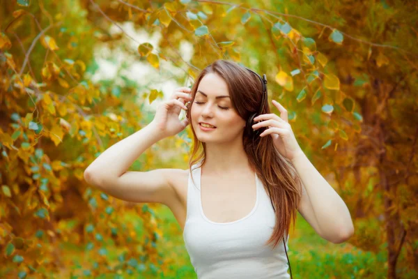 Menina adolescente em fones de ouvido na natureza — Fotografia de Stock