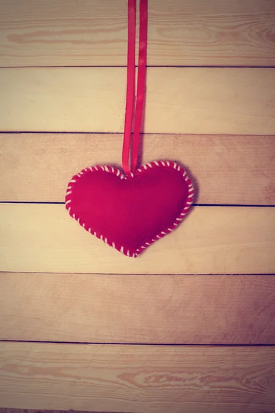 Textile red heart  on a wooden texture — Stock Photo, Image