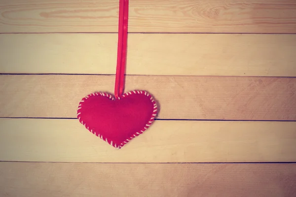 Textile red heart  on a wooden texture — Stock Photo, Image