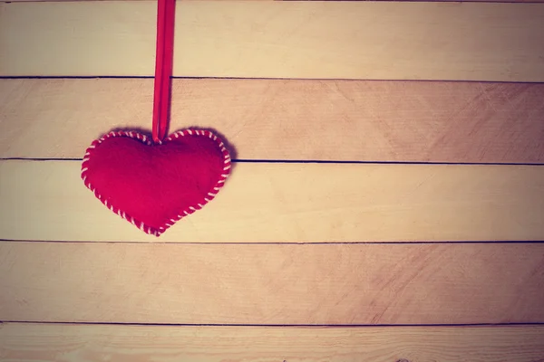 Textile red heart  on a wooden texture — Stock Photo, Image