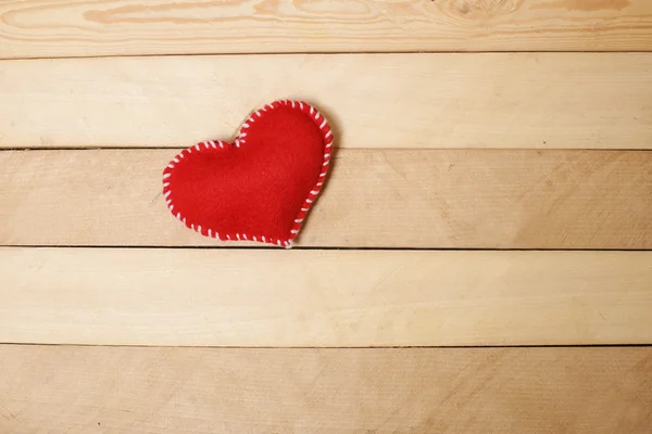 Textile red heart  on  wooden texture — Stock Photo, Image