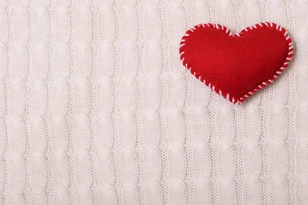 Textile red heart on a  knitted texture — Stock Photo, Image