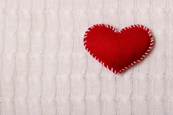 Textile red heart on a  knitted texture — Stock Photo, Image