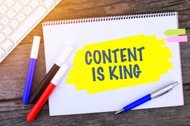 ContenENT 'li Not Defteri ahşap arka planda ve Modern Bilgisayar Klavyesinde elle yazılmış. Üst Görünüm Bileşimi