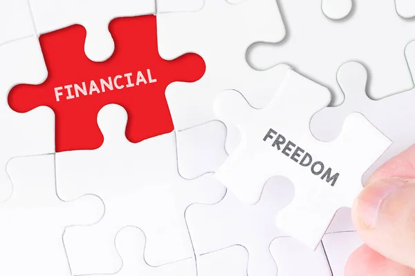 Female Hand Missing Puzzle Financial Freedom Word — Stock Photo, Image
