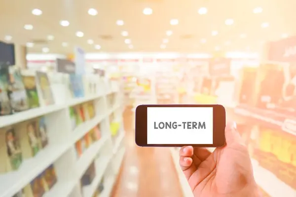 Conceito Negócio Palavra Long Term Smartphone Com Biblioteca Segundo Plano — Fotografia de Stock