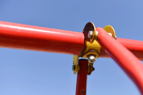 Connection joint of stainless steel pipe at a child's swing in a — Stock Photo, Image