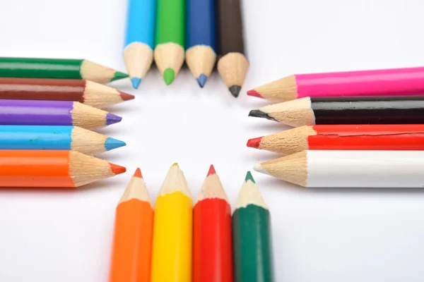 Close up picture of many little colored pencil crayons on white