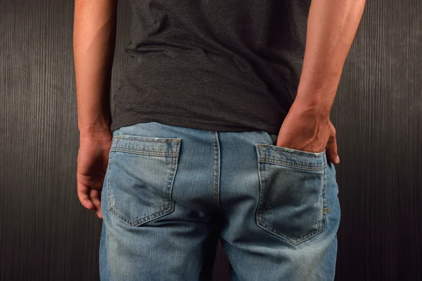 Back of hands and the right hand in the pocket of his blue jeans — Stock Photo, Image