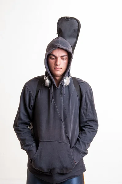 Bilden av tonåring i svarta kläder och hoodie med hörlurar är — Stockfoto