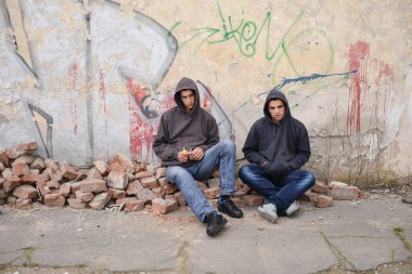 İki sokak holiganlar veya karşı bir grafiti boya oturan rapçiler