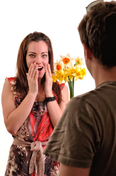 Surprised woman receiving a bouquet of flowers from his boyfrien — Stock Photo, Image