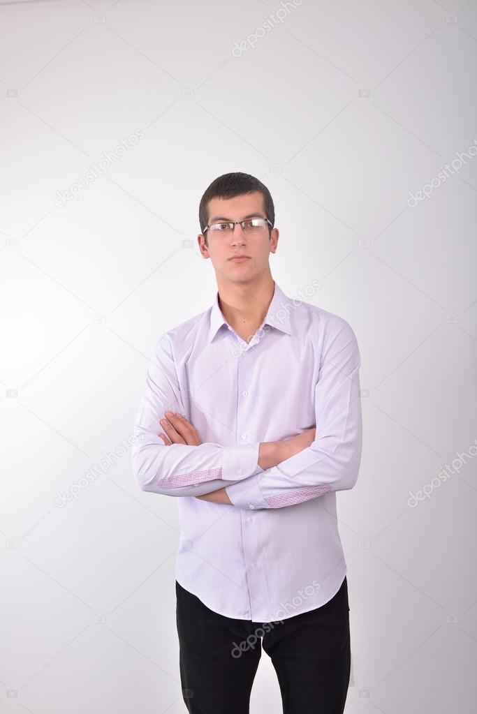 Portrait of a smart serious young man with glasses standing with