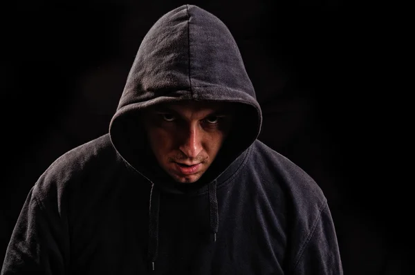 Man with hoodie or hooligan over dark background — Stock Photo, Image