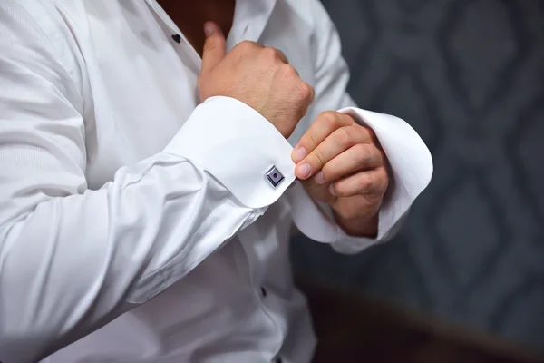 Primo piano di un uomo mano come indossa camicia bianca e gemello — Foto Stock