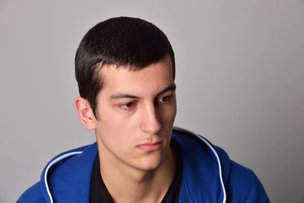 Thinker attractive young man in a blue hoodie — Stock Photo, Image