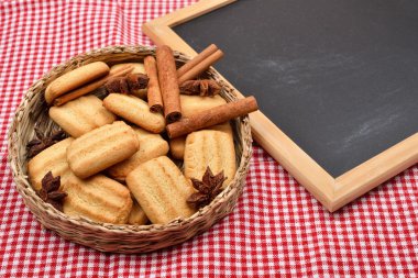 Biscuits for Christmas with cinnamon and anise near a blank blac