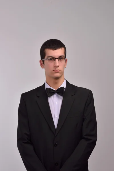 Profile portrait of a fashion young man with glasses in black su — Stock Photo, Image