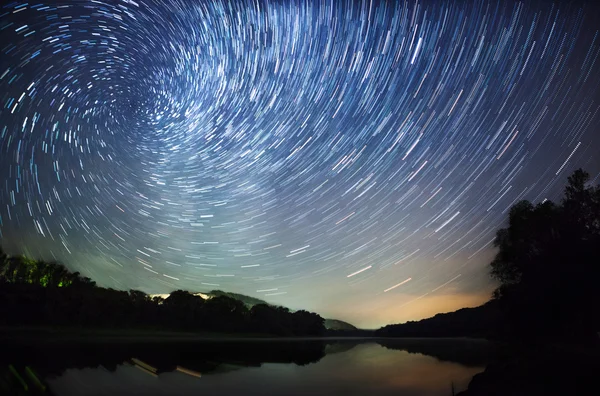 A beautiful night sky, the Milky Way, star trails and the trees — Stock Photo, Image