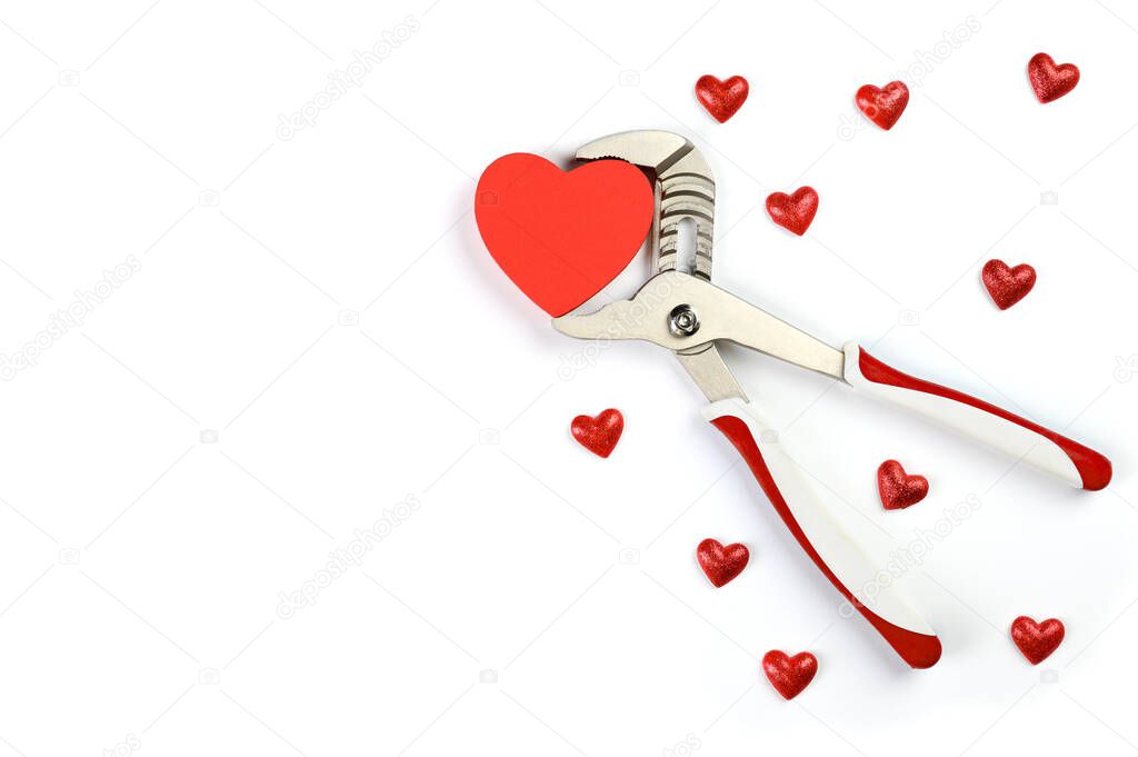 Wrench with hearts isolated on background. The concept of your favorite profession and Valentine's Day.