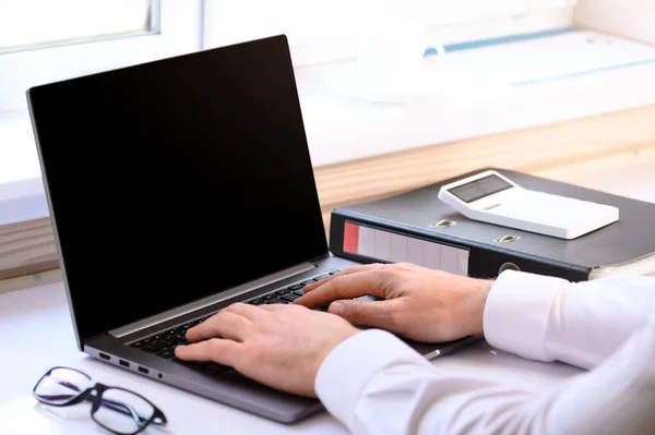 Accounting courses. On the table there is a computer and a folder with business papers. Online learning