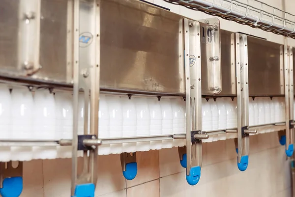 filling milk in to plastic bottles at the factory. equipment at the dairy plant