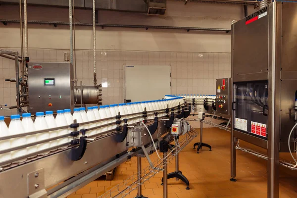 filling milk in to plastic bottles at the factory. equipment at the dairy plant