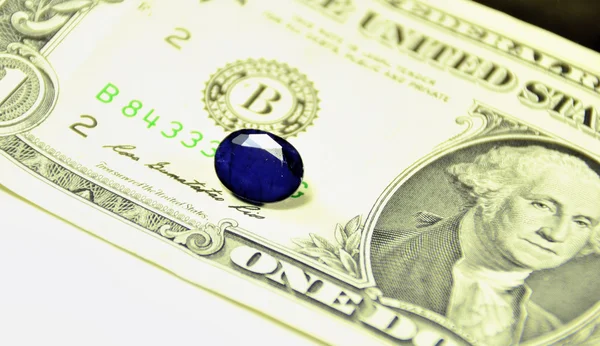 Sapphire gemstone against the dollar. macro