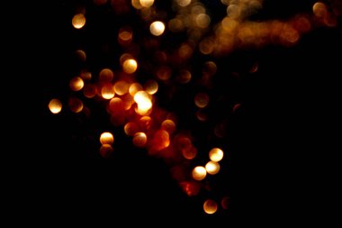 Bulanık altın ve kırmızı parıltılardan arkaplan.