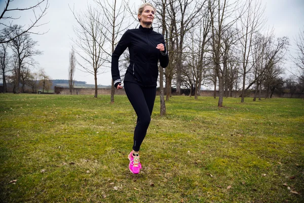 Žena běží v parku — Stock fotografie