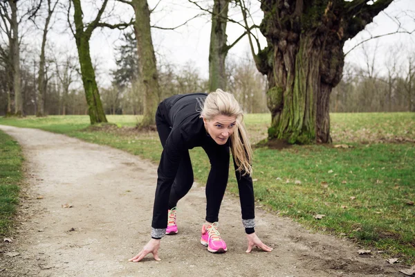 Woman getting ready to run — Stock Photo, Image