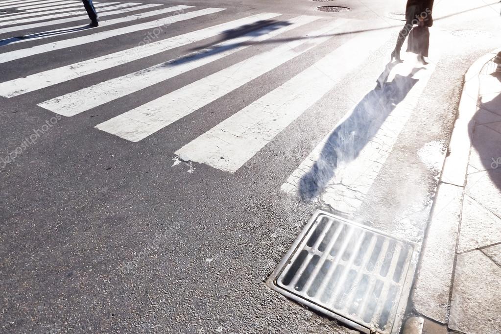 Pedestrians cross zebra stripes in Manhattan