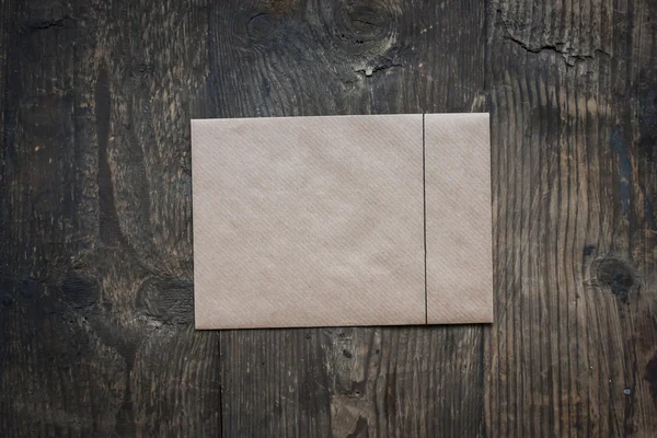 Brown envelope on wooden background — Stock Photo, Image