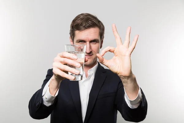 Studio shot of happy businessman drinking water — Stock Fotó