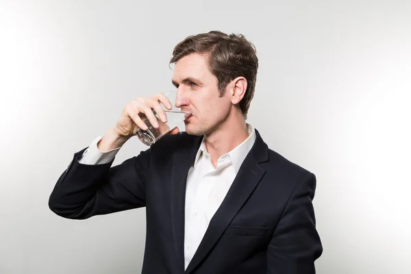 Studio shot of happy businessman drinking water — Stock Fotó
