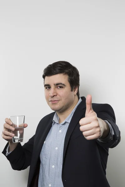 Studio shot of happy businessman drinking water — Stock Fotó