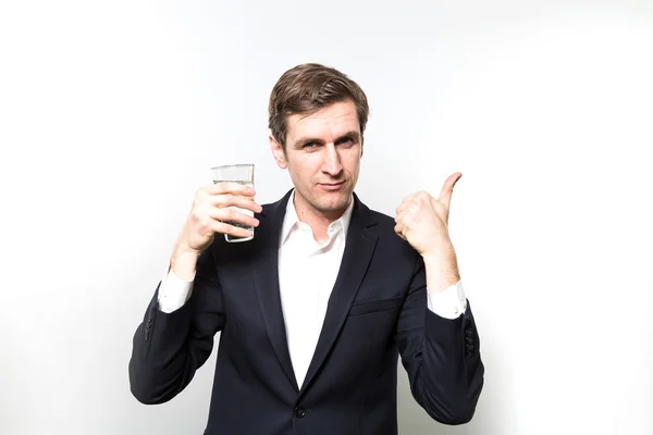 Studio shot of happy businessman drinking water — 图库照片