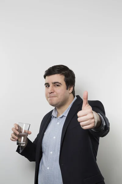 Studio shot of happy businessman drinking water — Stock Fotó