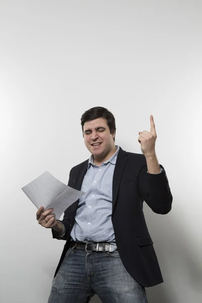 Studio shot of happy businessman celebrating a paper — Zdjęcie stockowe