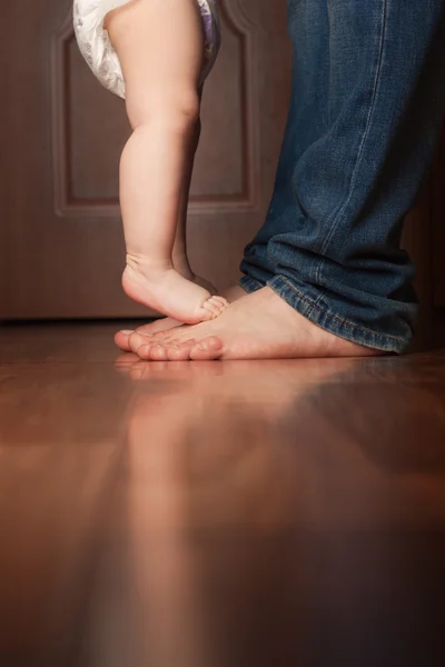 Baby feet and father