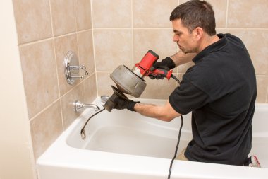 Plumber Working on Drain clipart