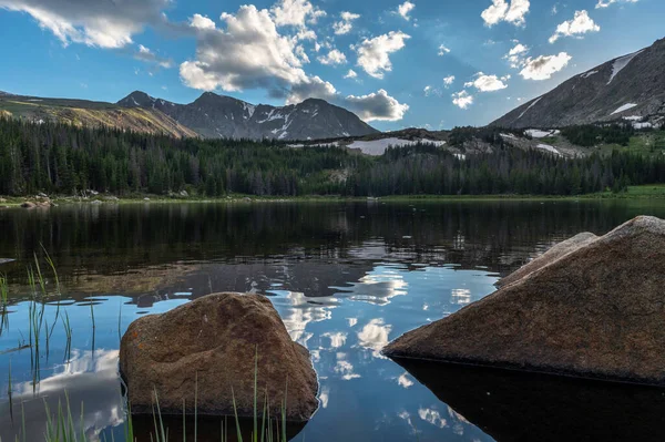 Rocks on the shore of Lost Lake, Sunset, summer time, Rocky Mountain National Park