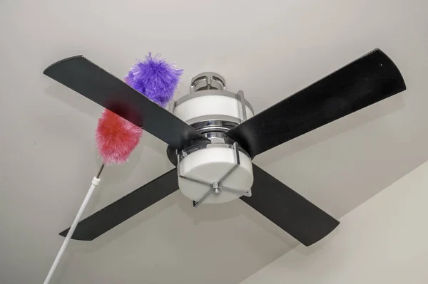 Colorful duster on dusty bedroom fan