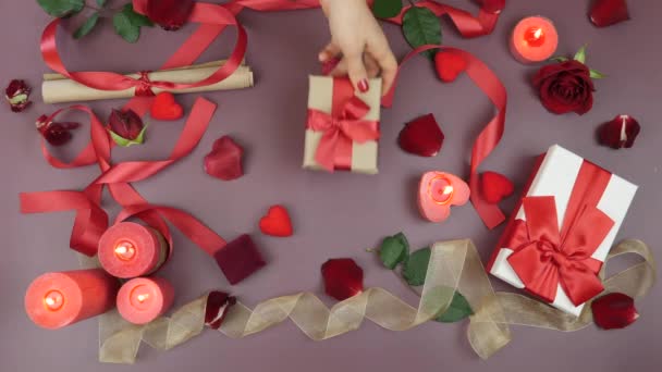 Weibliche Hand schenkt männliche Hand zum Valentinstag. Mann erhält verpacktes Geschenk mit gebundener roter Schleife. Weihnachtsgeschenke — Stockvideo