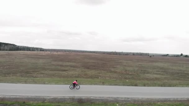 Riding bicycle outdoor. Woman cycling. Athlete training on bike on empty road — Stock Video