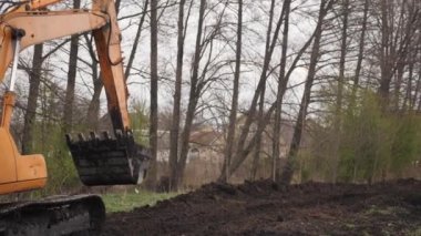 Excavator tractor caterpillar at construction site. Heavy tractors. Tank wheels
